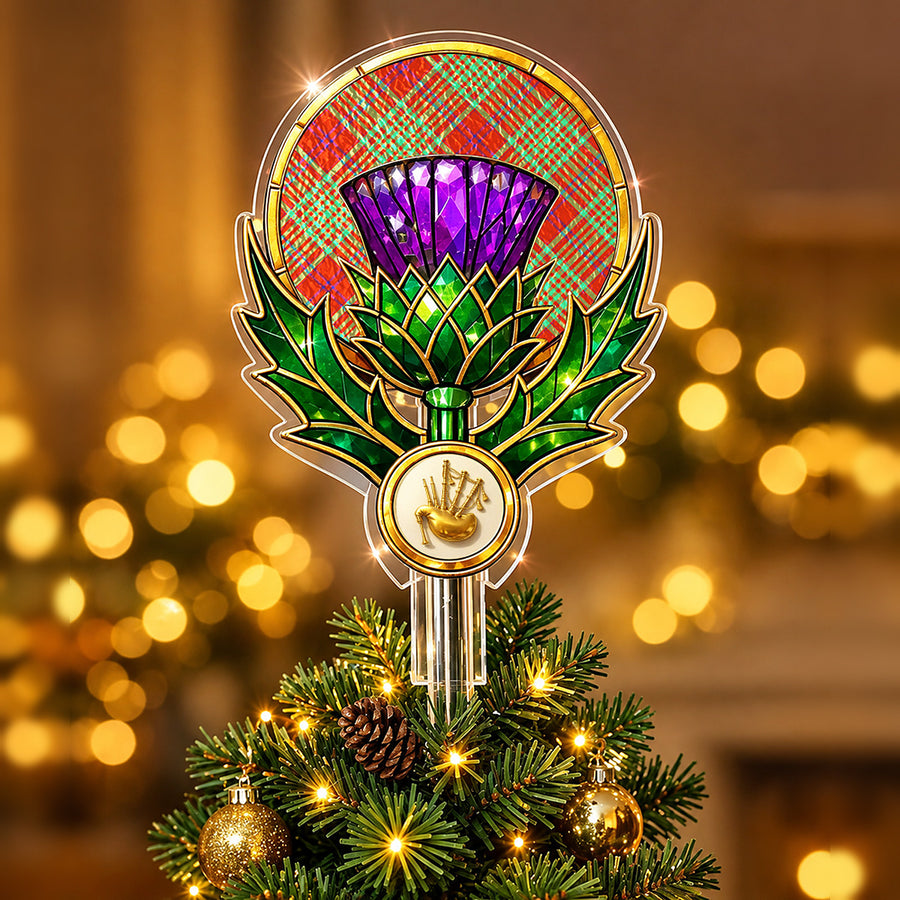 Stained-glass style thistle Christmas tree topper with a gold bagpipe emblem and the MacGillivray Hunting Ancient tartan behind the thistle