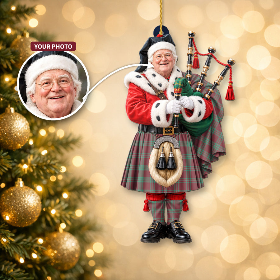 Christmas piper ornament in the MacGregor Hunting Ancient tartan hanging on a Christmas tree, with the customer photo used for the face
