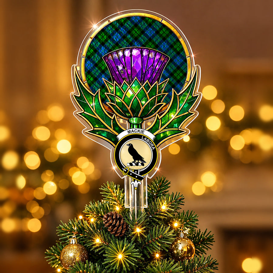 Clan MacKie crest in the centre of a stained-glass style thistle Christmas tree topper with the MacKie tartan behind the thistle