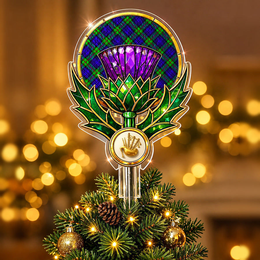 Stained-glass style thistle Christmas tree topper with a gold bagpipe emblem and the MacKinlay Modern tartan behind the thistle