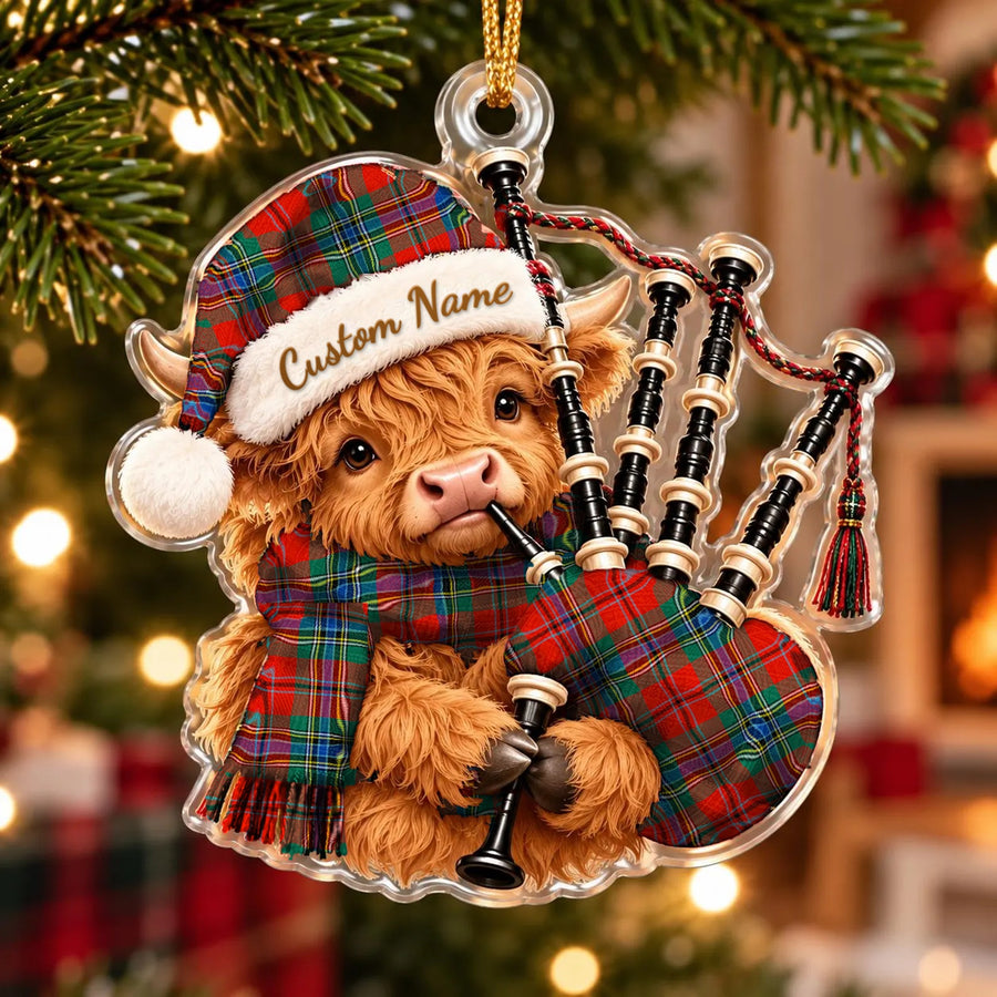 Acrylic Highland cow calf ornament playing the bagpipes, in a MacLean of Duart Ancient tartan Santa hat, scarf and pipe bag, with a custom name on the hat