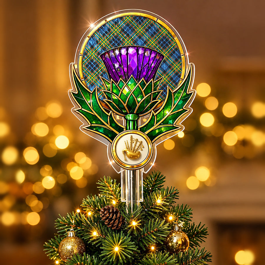 Stained-glass style thistle Christmas tree topper with a gold bagpipe emblem and the MacLellan Ancient tartan behind the thistle