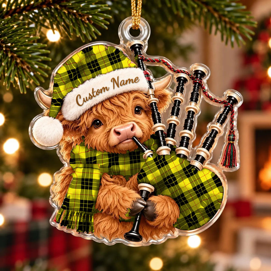 Acrylic Highland cow calf ornament playing the bagpipes, in a MacLeod of Lewis Modern tartan Santa hat, scarf and pipe bag, with a custom name on the hat