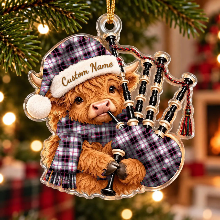 Acrylic Highland cow calf ornament playing the bagpipes, in a MacPherson Hunting Modern tartan Santa hat, scarf and pipe bag, with a custom name on the hat