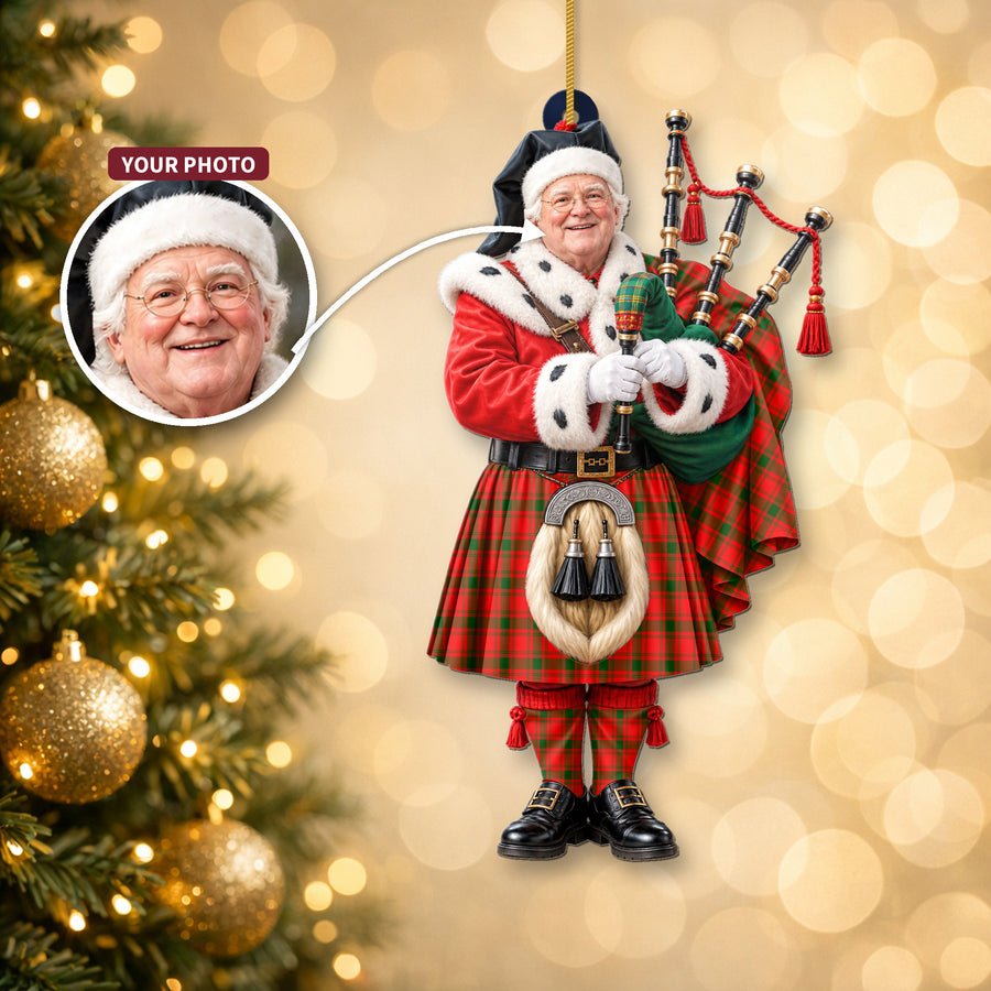 Christmas piper ornament in the MacQuarrie Modern tartan hanging on a Christmas tree, with the customer photo used for the face