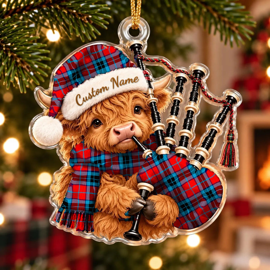 Acrylic Highland cow calf ornament playing the bagpipes, in a MacTavish Modern tartan Santa hat, scarf and pipe bag, with a custom name on the hat