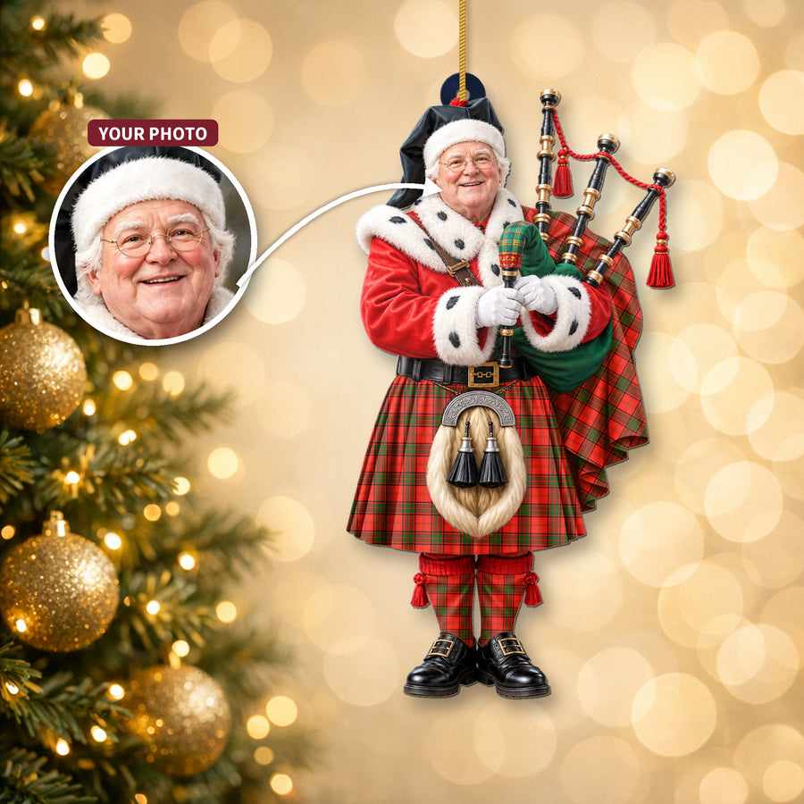 Christmas piper ornament in the Maxtone tartan hanging on a Christmas tree, with the customer photo used for the face