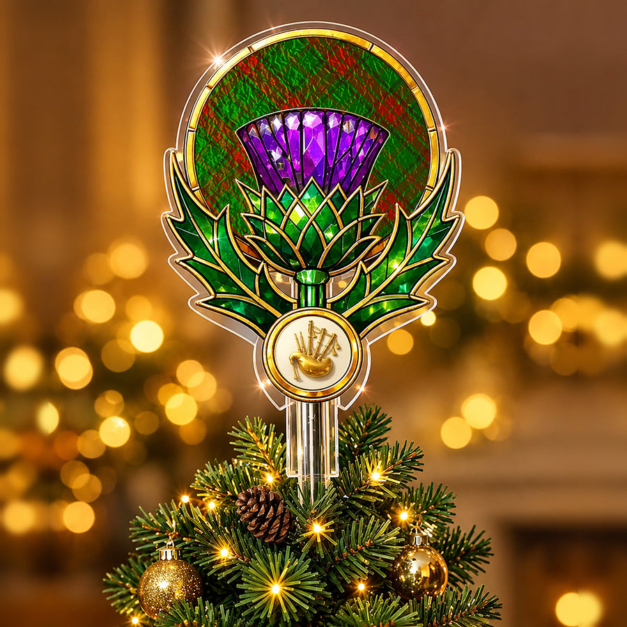 Stained-glass style thistle Christmas tree topper with a gold bagpipe emblem and the Maxwell Hunting tartan behind the thistle
