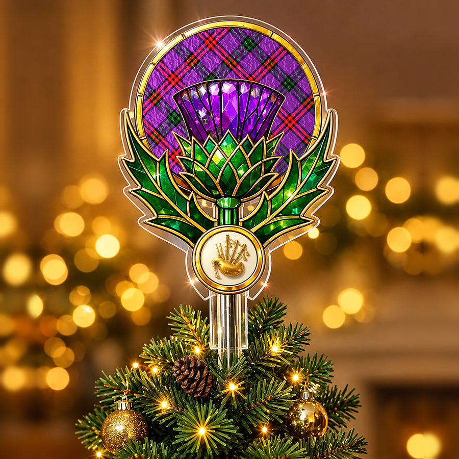 Stained-glass style thistle Christmas tree topper with a gold bagpipe emblem and the Montgomery Modern tartan behind the thistle