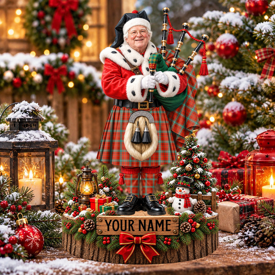 Personalized Christmas piper plaque in the Morrison Red Ancient tartan, standing on a snowy log base with a name plaque