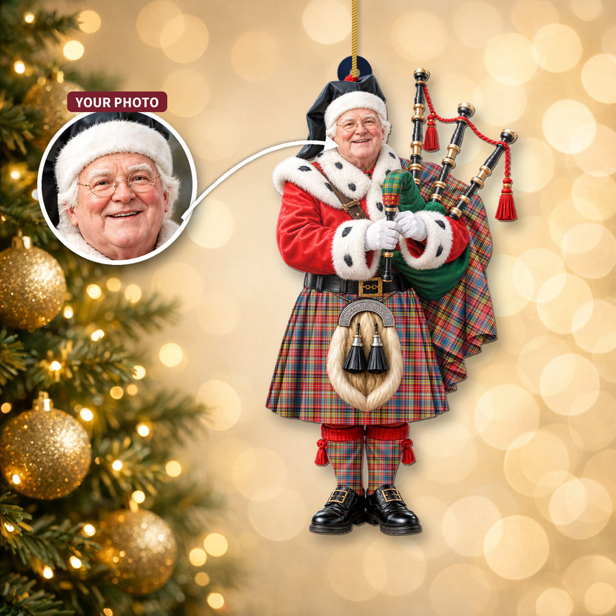 Christmas piper ornament in the Ogilvie of Airlie Ancient tartan hanging on a Christmas tree, with the customer photo used for the face