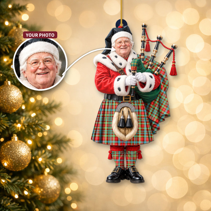 Christmas piper ornament in the Ogilvie tartan hanging on a Christmas tree, with the customer photo used for the face