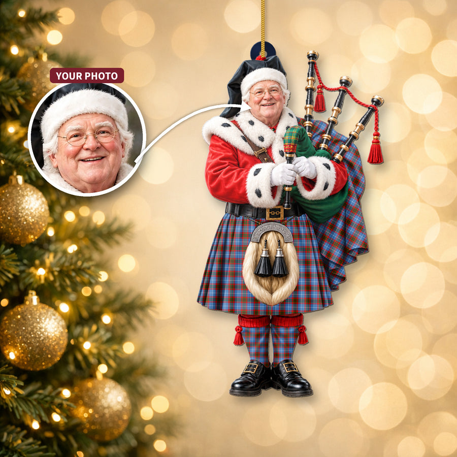 Christmas piper ornament in the Pentland (Edinburgh) tartan hanging on a Christmas tree, with the customer photo used for the face