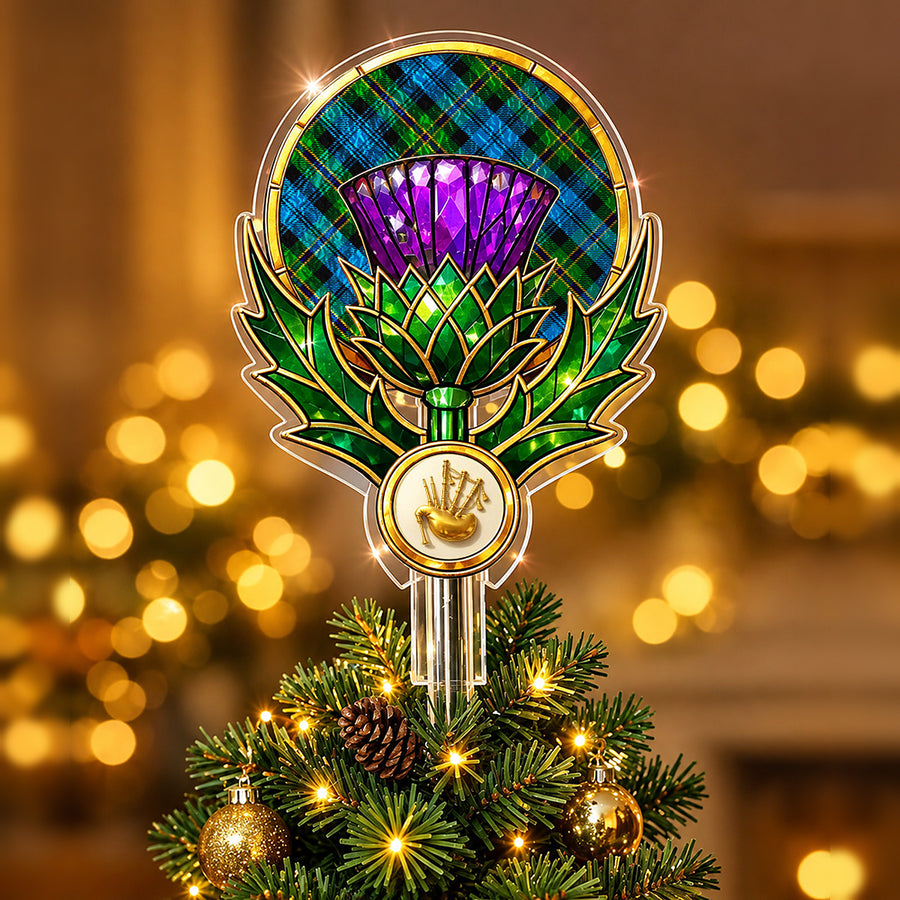 Stained-glass style thistle Christmas tree topper with a gold bagpipe emblem and the Polaris Military tartan behind the thistle