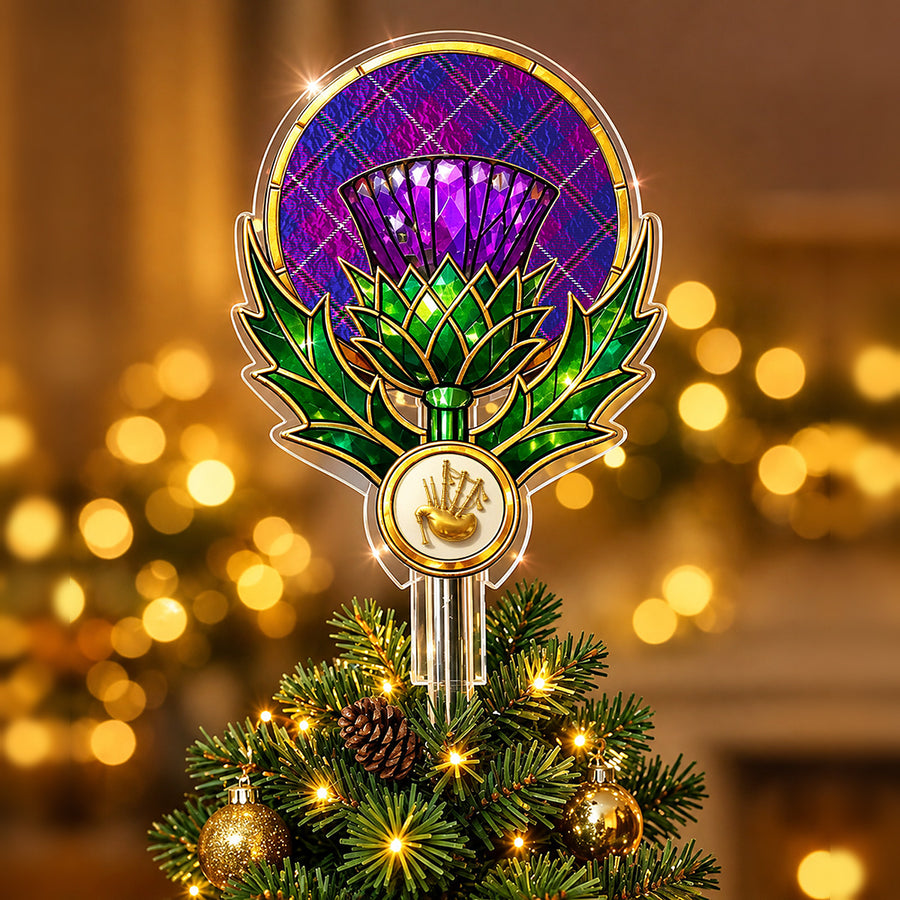 Stained-glass style thistle Christmas tree topper with a gold bagpipe emblem and the Pride of Glencoe tartan behind the thistle