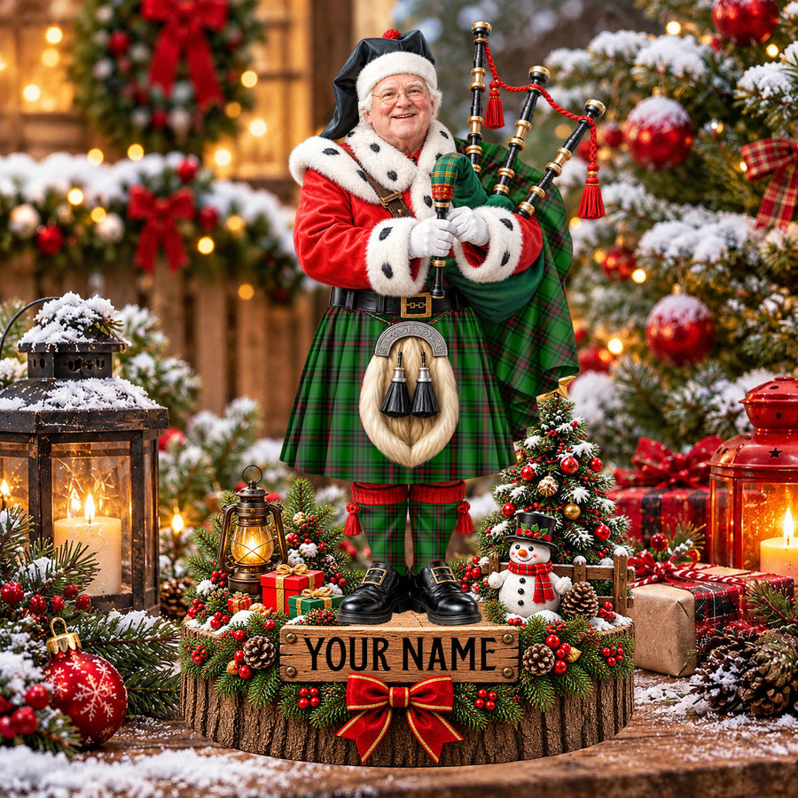 Personalized Christmas piper plaque in the Primrose (Fife) tartan, standing on a snowy log base with a name plaque
