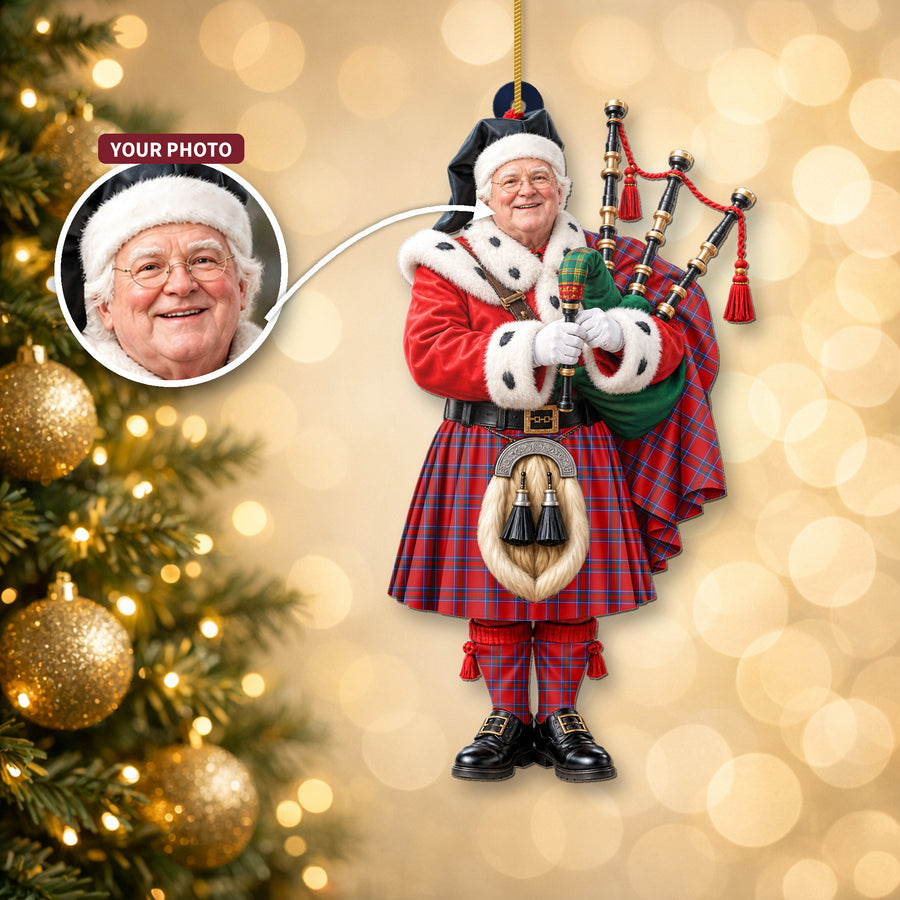 Christmas piper ornament in the Rait Inverness tartan hanging on a Christmas tree, with the customer photo used for the face