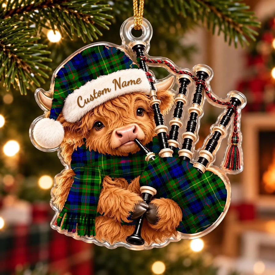 Acrylic Highland cow calf ornament playing the bagpipes, in a Rollo tartan Santa hat, scarf and pipe bag, with a custom name on the hat
