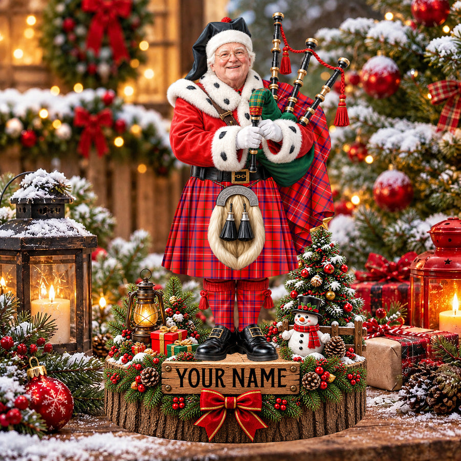 Personalized Christmas piper plaque in the Rose tartan, standing on a snowy log base with a name plaque