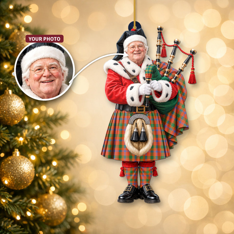 Christmas piper ornament in the Ross Ancient tartan hanging on a Christmas tree, with the customer photo used for the face