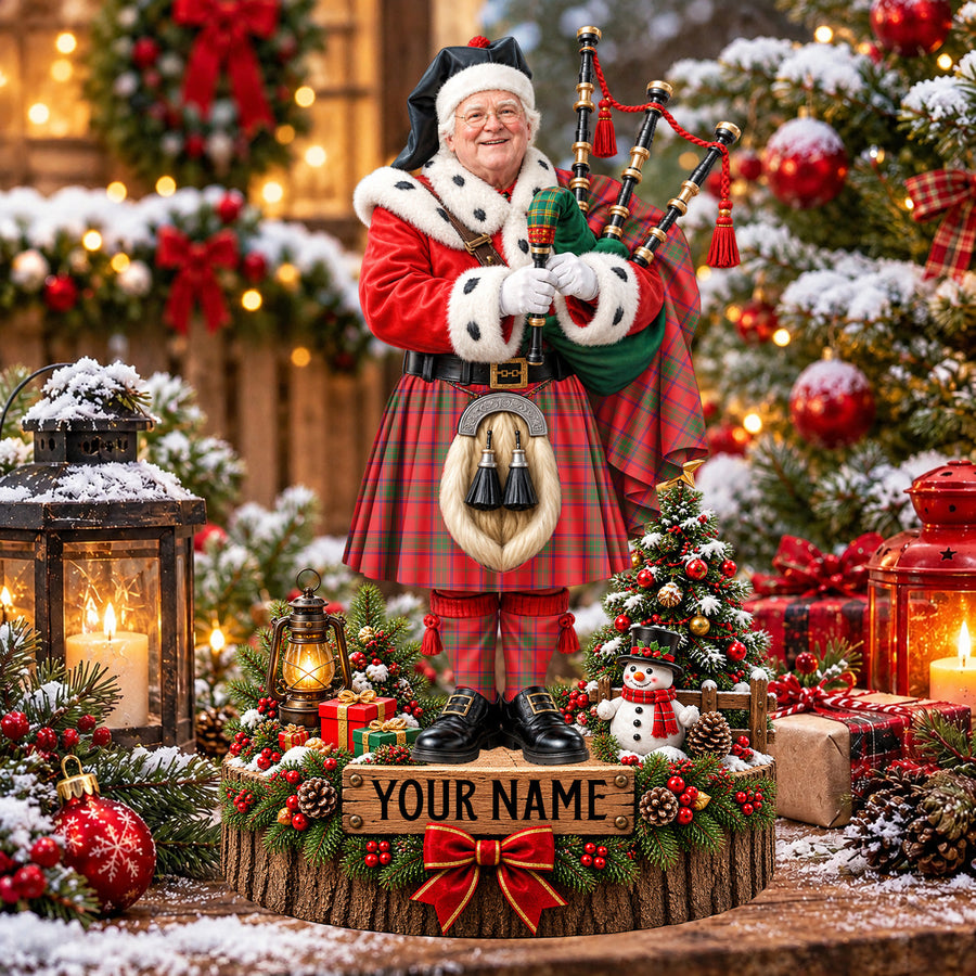Personalized Christmas piper plaque in the Ross Modern tartan, standing on a snowy log base with a name plaque