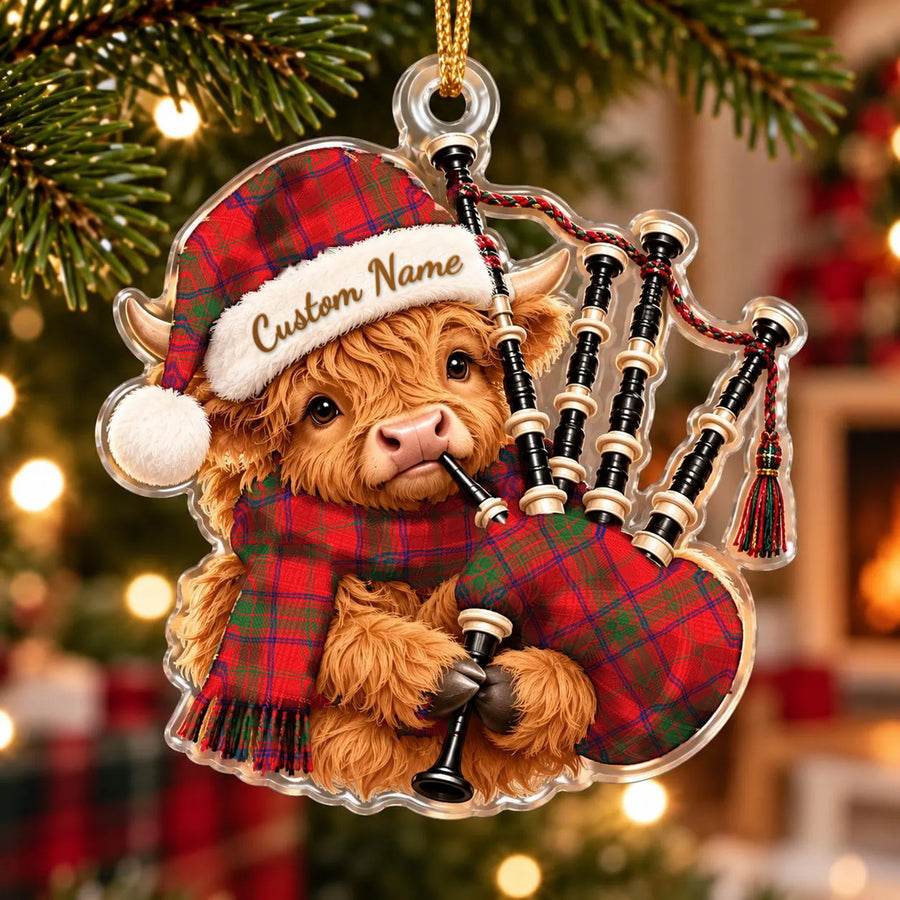 Acrylic Highland cow calf ornament playing the bagpipes, in a Ross Modern tartan Santa hat, scarf and pipe bag, with a custom name on the hat