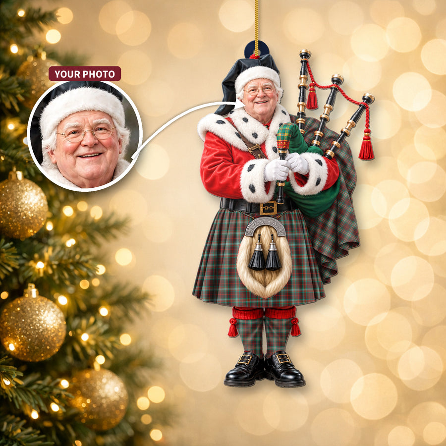 Christmas piper ornament in the Scott Brown Ancient tartan hanging on a Christmas tree, with the customer photo used for the face