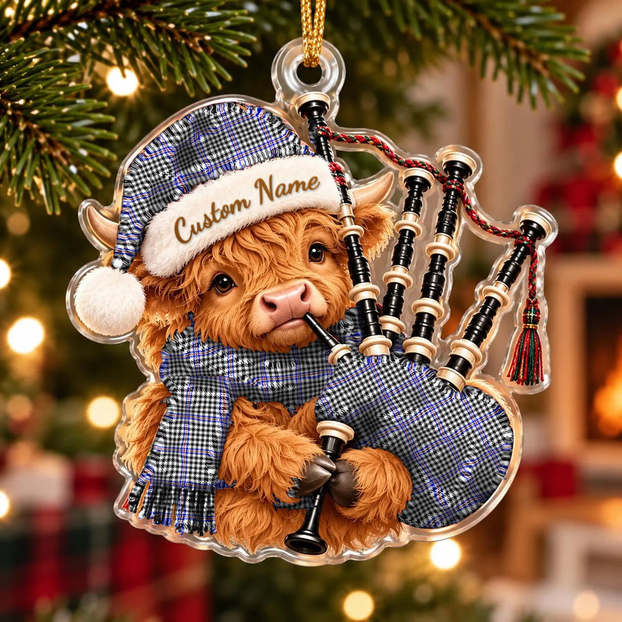 Acrylic Highland cow calf ornament playing the bagpipes, in a Sir Walter Scott tartan Santa hat, scarf and pipe bag, with a custom name on the hat