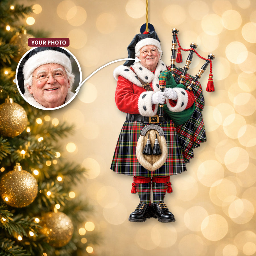 Christmas piper ornament in the Stewart Black tartan hanging on a Christmas tree, with the customer photo used for the face