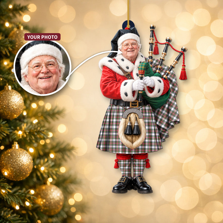 Christmas piper ornament in the Stewart Dress Modern tartan hanging on a Christmas tree, with the customer photo used for the face