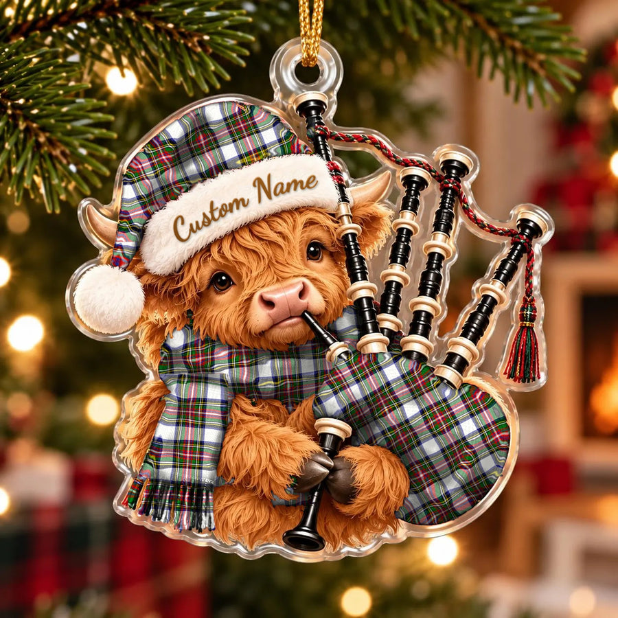 Acrylic Highland cow calf ornament playing the bagpipes, in a Stewart Dress Modern tartan Santa hat, scarf and pipe bag, with a custom name on the hat