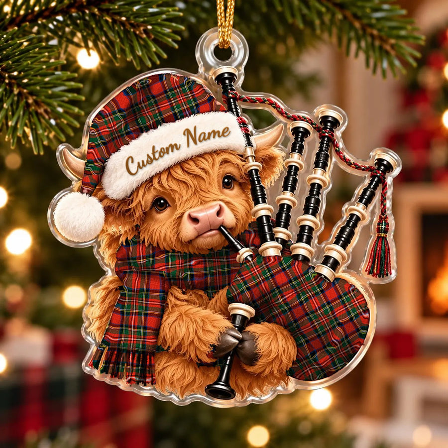 Acrylic Highland cow calf ornament playing the bagpipes, in a Stewart (of Appin) tartan Santa hat, scarf and pipe bag, with a custom name on the hat