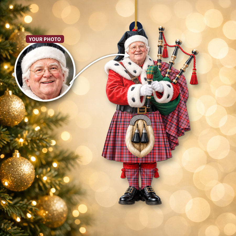Christmas piper ornament in the Straiton Aderbeen tartan hanging on a Christmas tree, with the customer photo used for the face