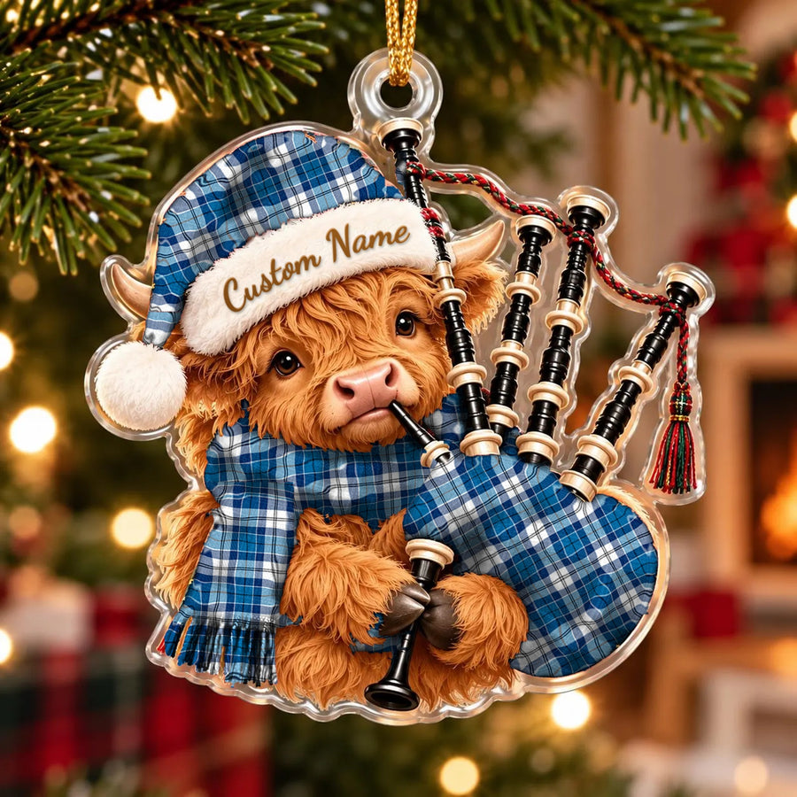 Acrylic Highland cow calf ornament playing the bagpipes, in a Strathclyde District tartan Santa hat, scarf and pipe bag, with a custom name on the hat