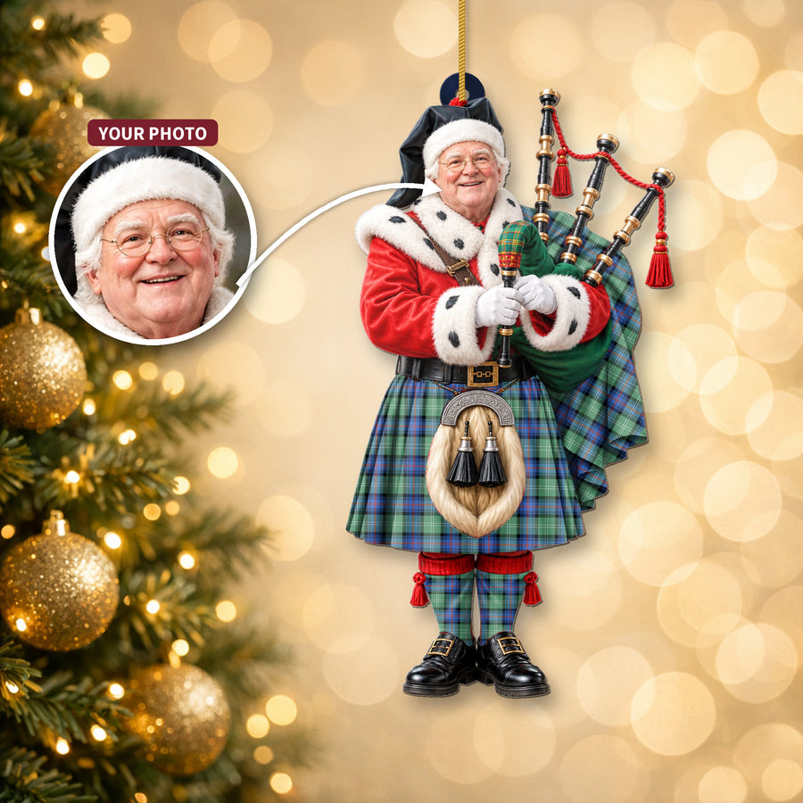 Christmas piper ornament in the Sutherland Old Ancient tartan hanging on a Christmas tree, with the customer photo used for the face