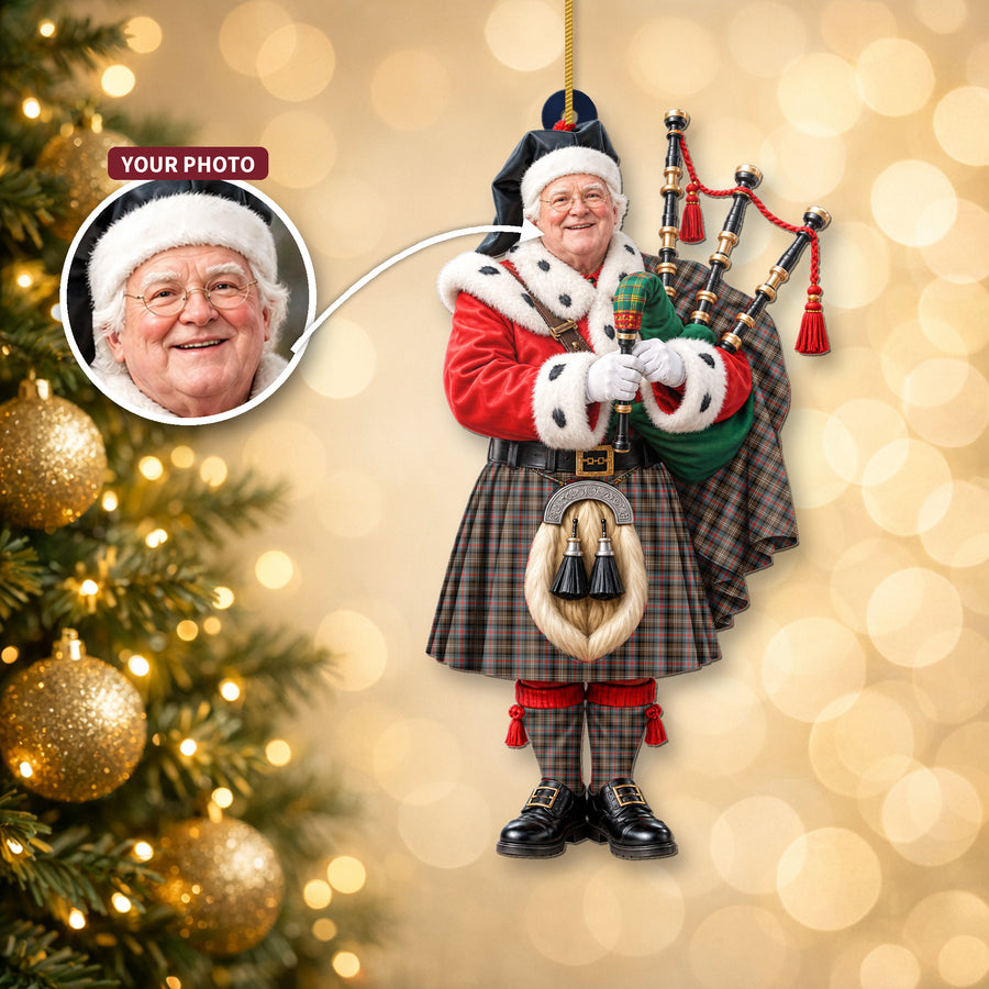 Christmas piper ornament in the Sutherland Weathered tartan hanging on a Christmas tree, with the customer photo used for the face