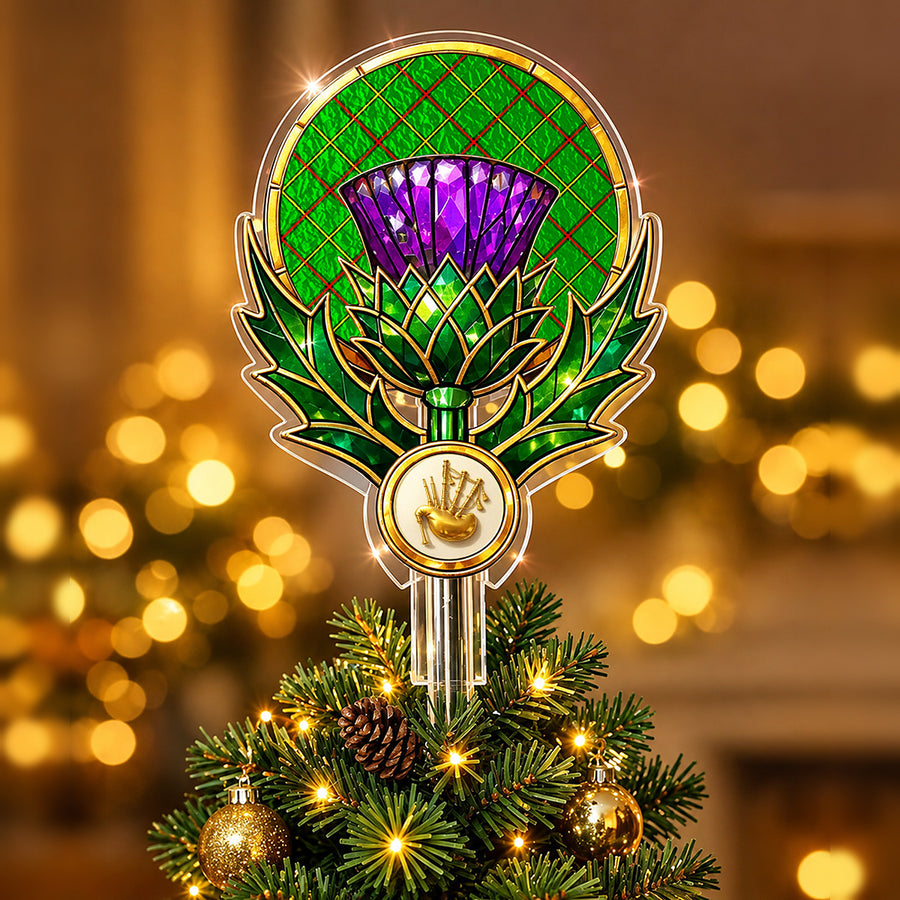 Stained-glass style thistle Christmas tree topper with a gold bagpipe emblem and the Tribe of Mar tartan behind the thistle