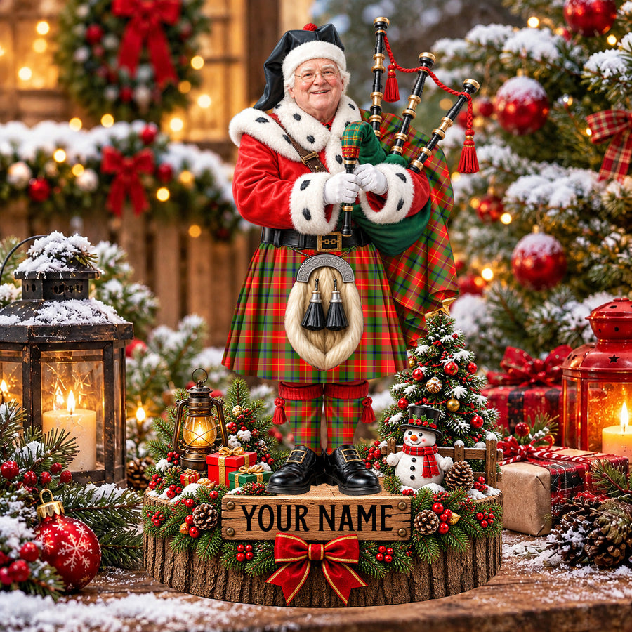 Personalized Christmas piper plaque in the Turnbull Dress tartan, standing on a snowy log base with a name plaque