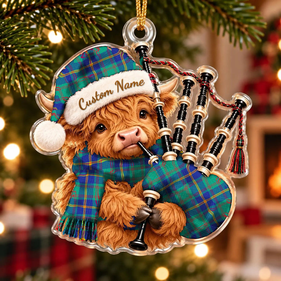 Acrylic Highland cow calf ornament playing the bagpipes, in a US Marine tartan Santa hat, scarf and pipe bag, with a custom name on the hat