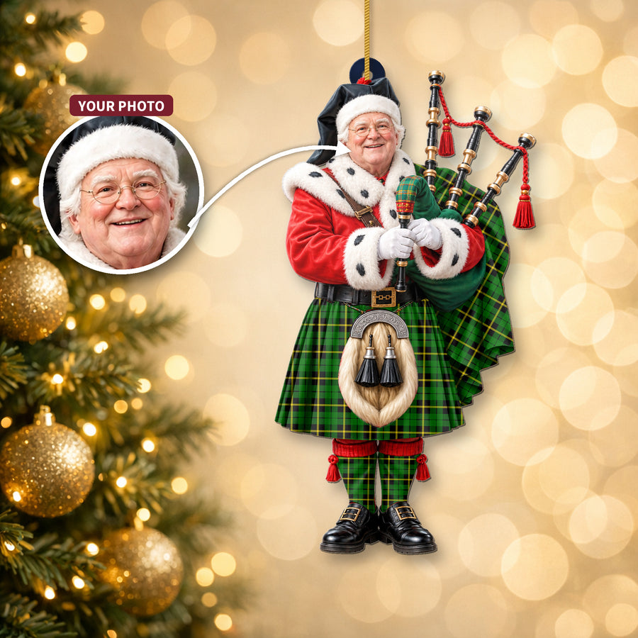Christmas piper ornament in the Wallace Hunting Green tartan hanging on a Christmas tree, with the customer photo used for the face