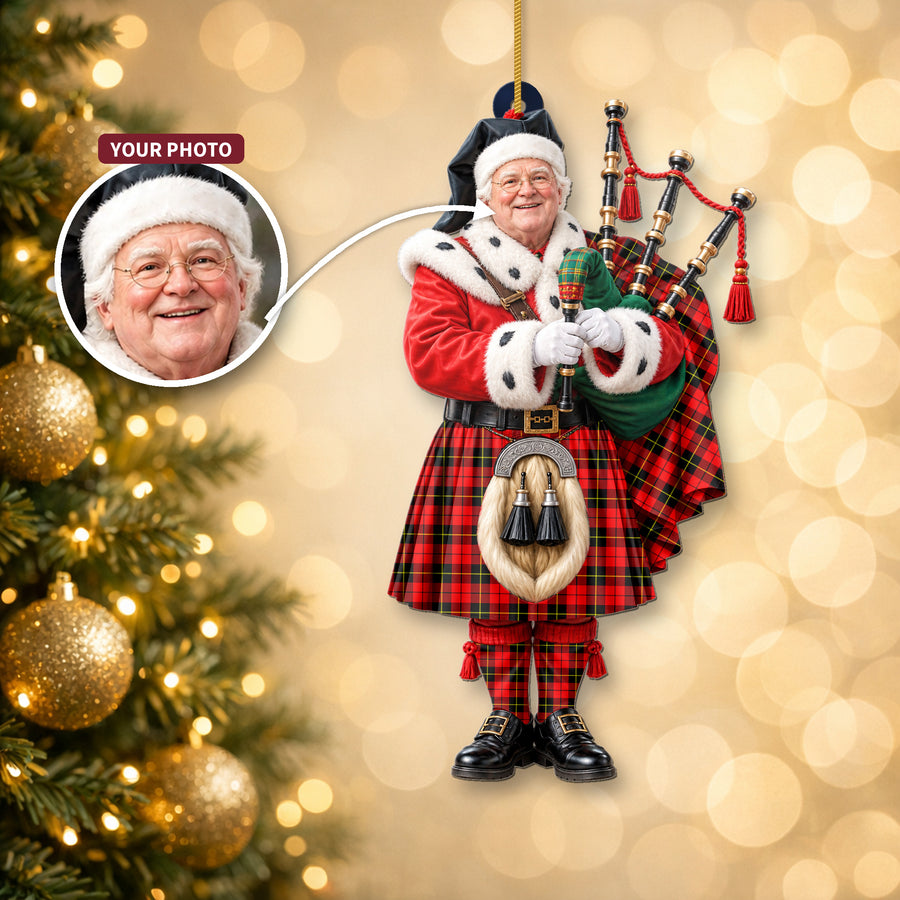 Christmas piper ornament in the Wallace Hunting Red tartan hanging on a Christmas tree, with the customer photo used for the face
