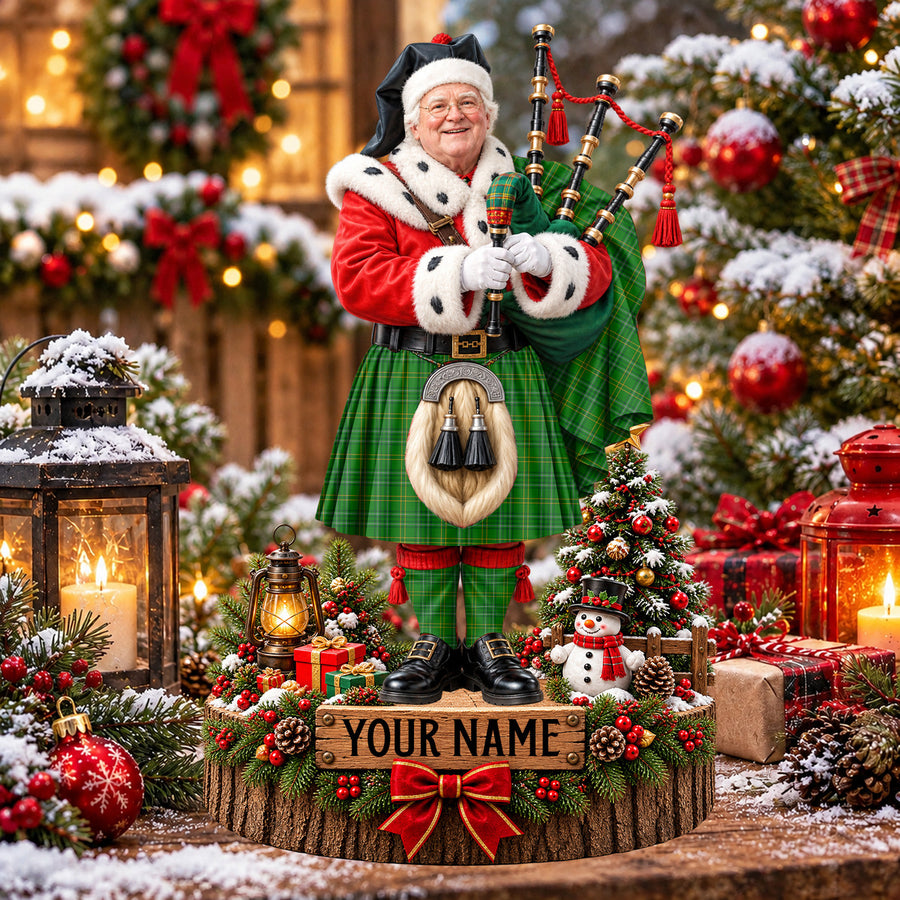 Personalized Christmas piper plaque in the Wexford County tartan, standing on a snowy log base with a name plaque