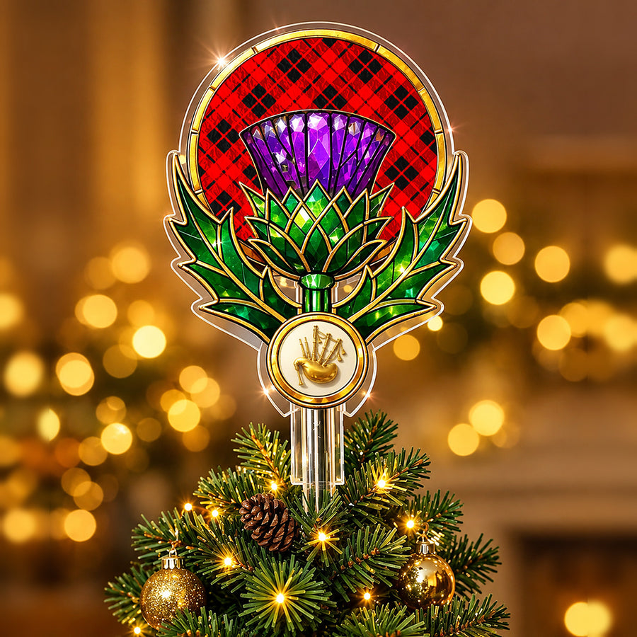 Stained-glass style thistle Christmas tree topper with a gold bagpipe emblem and the Ettrick District tartan behind the thistle