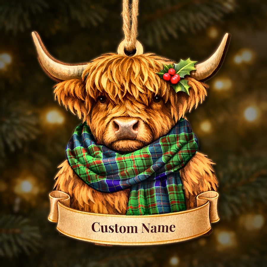 Wooden Highland cow Christmas ornament wearing a Adam tartan scarf, with a ribbon banner for a custom name