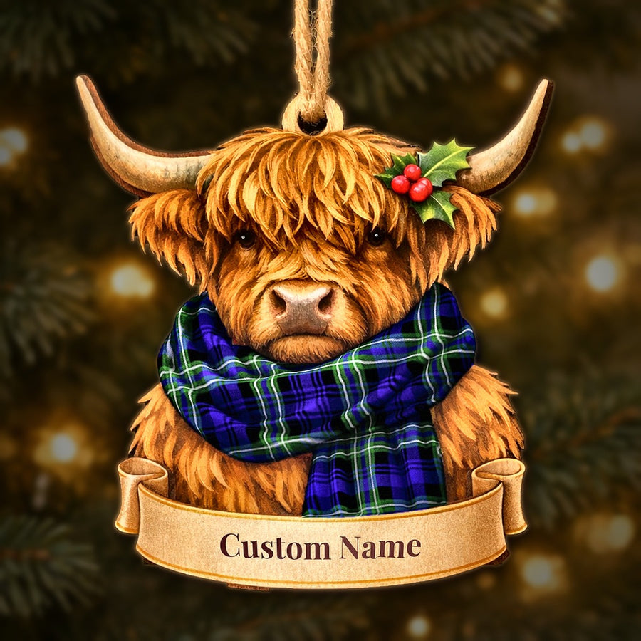 Wooden Highland cow Christmas ornament wearing a Arbuthnot Modern tartan scarf, with a ribbon banner for a custom name
