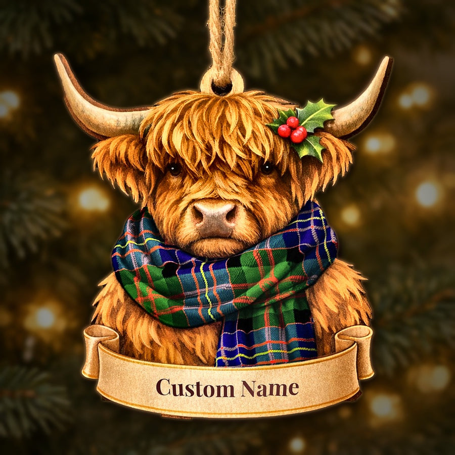 Wooden Highland cow Christmas ornament wearing a Cameron of Erracht Modern tartan scarf, with a ribbon banner for a custom name