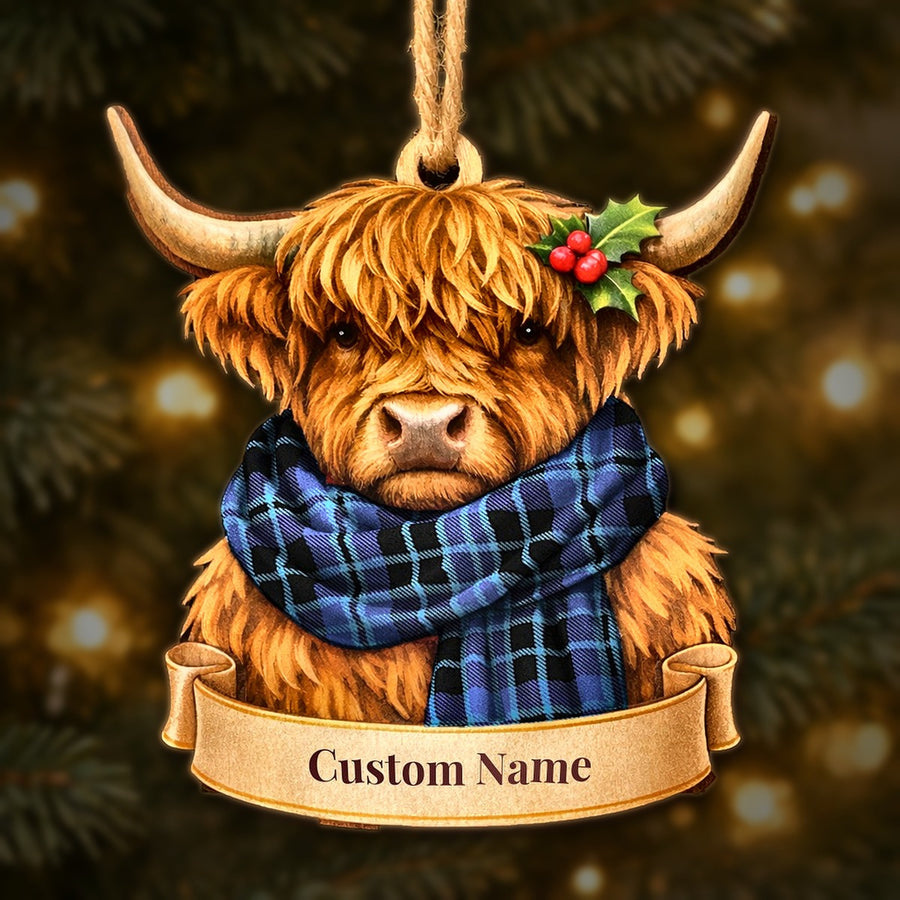 Wooden Highland cow Christmas ornament wearing a Clark 2 tartan scarf, with a ribbon banner for a custom name