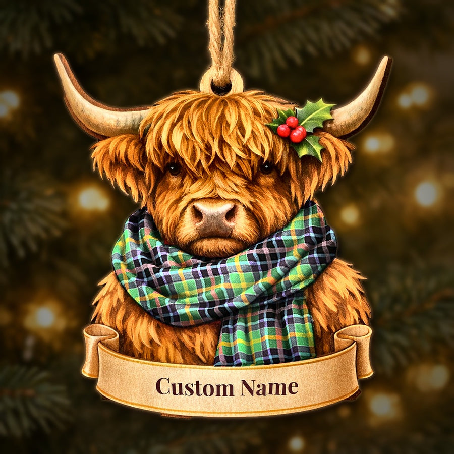 Wooden Highland cow Christmas ornament wearing a Clephane tartan scarf, with a ribbon banner for a custom name