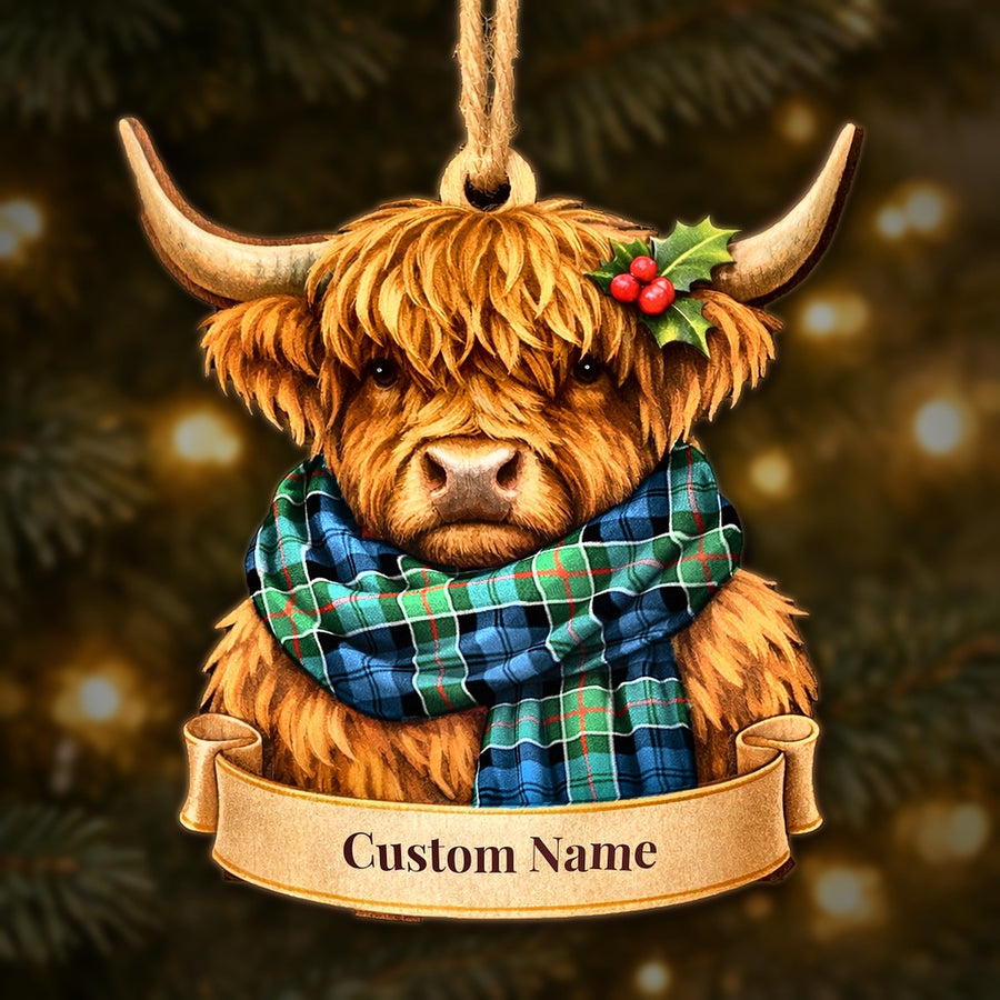 Wooden Highland cow Christmas ornament wearing a Colquhoun Ancient tartan scarf, with a ribbon banner for a custom name