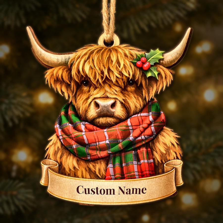 Wooden Highland cow Christmas ornament wearing a Crief District tartan scarf, with a ribbon banner for a custom name